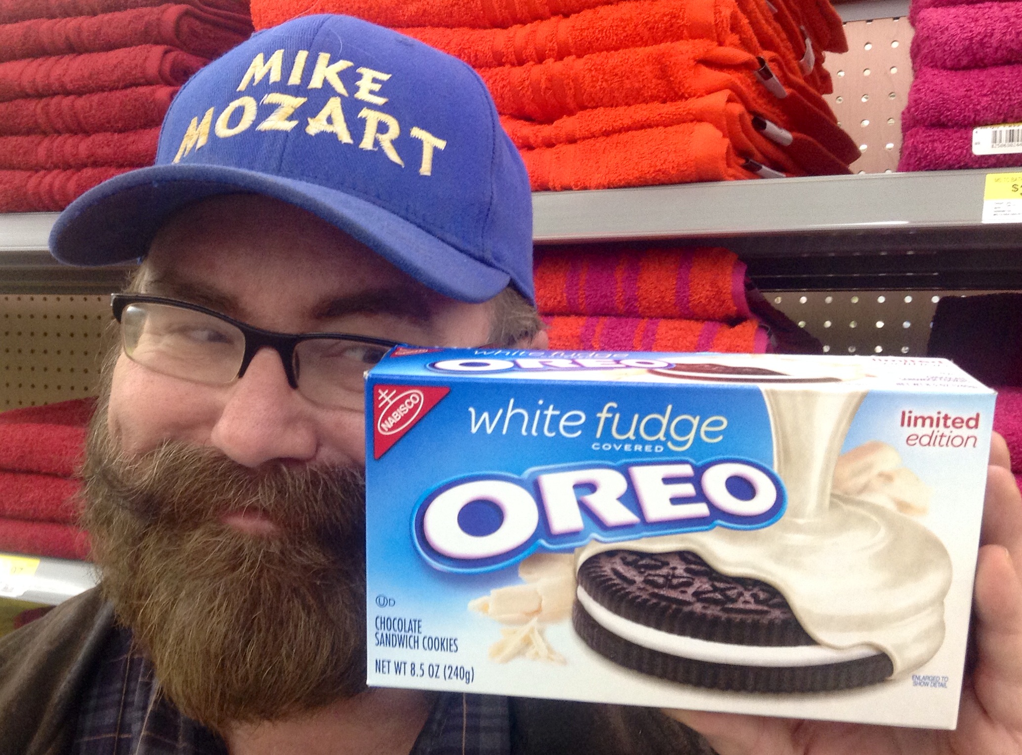 a bearded man is holding a box of oreo