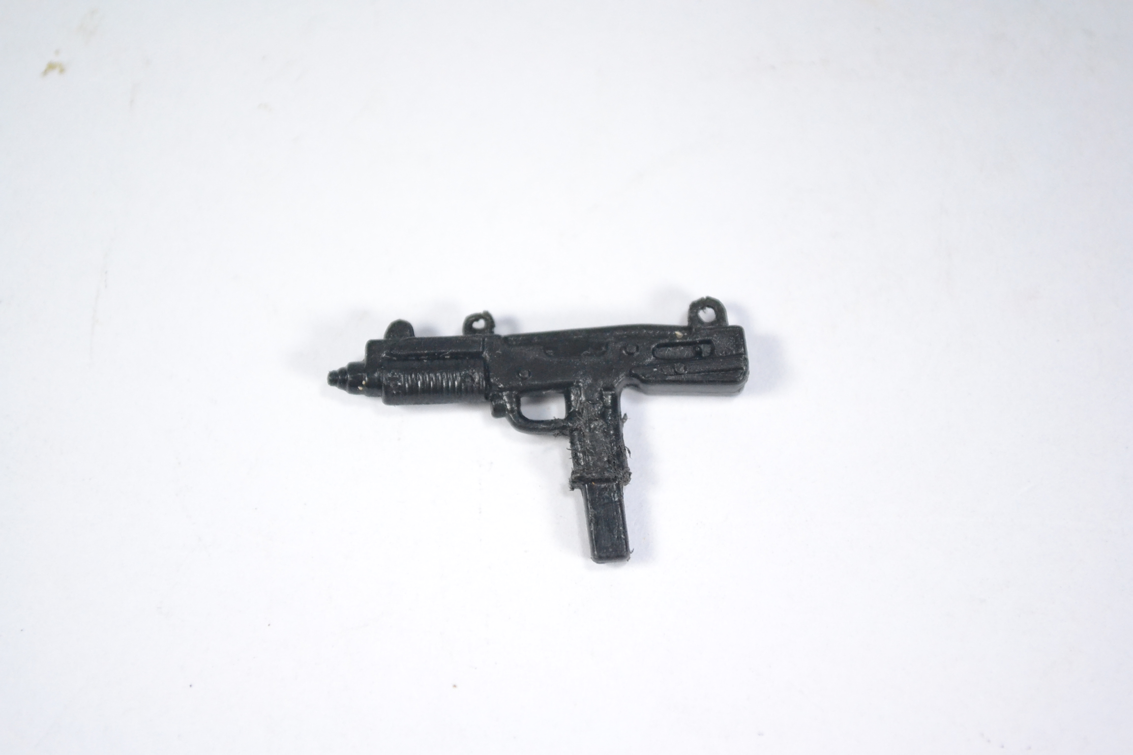 a toy gun that is laying on top of a table