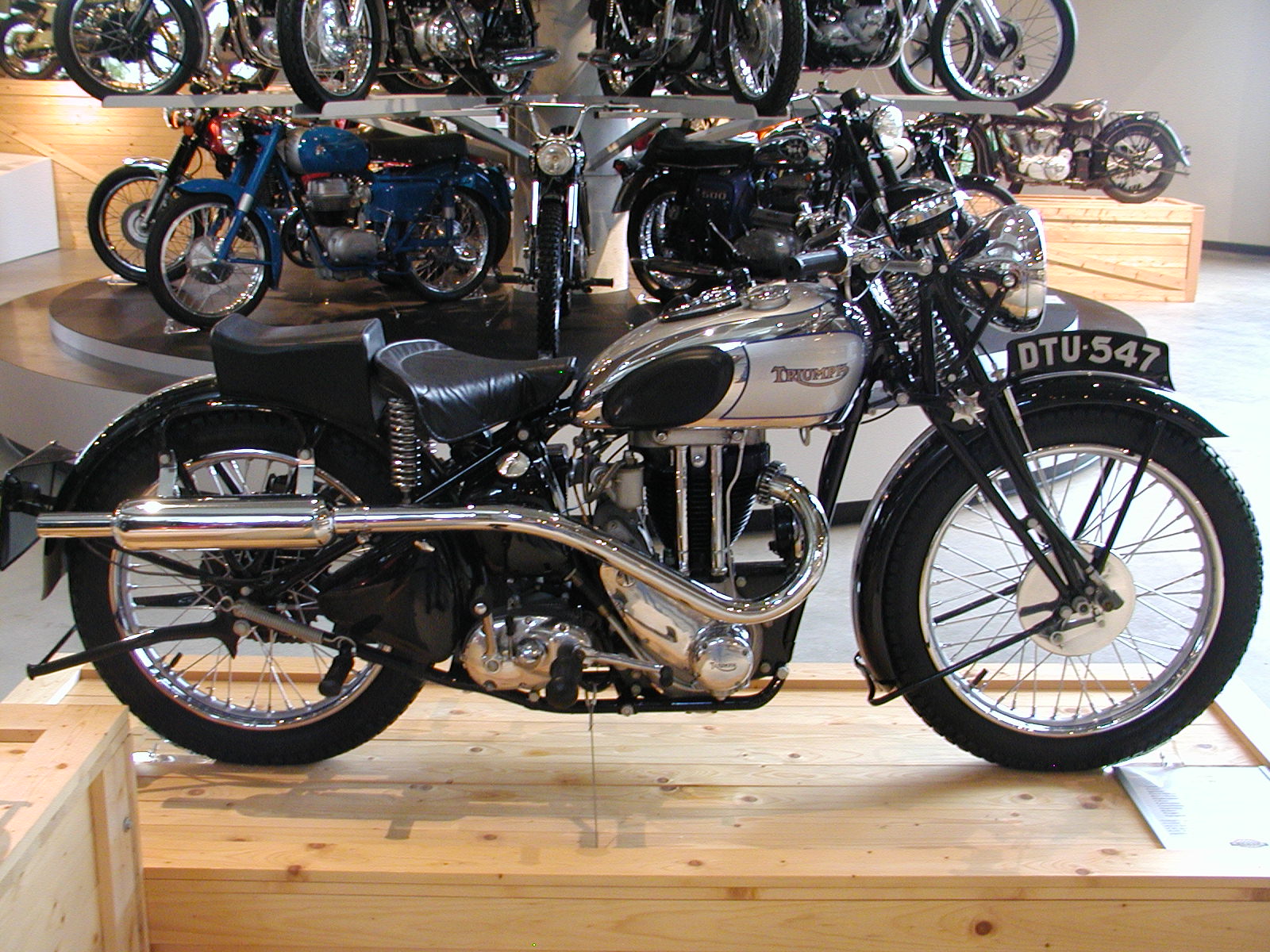 some people looking at a motorcycle on display