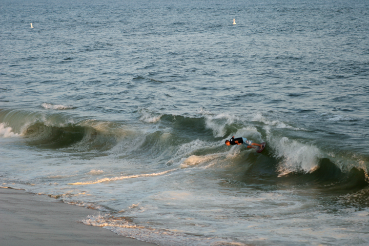 a surfer is riding the wave near shore