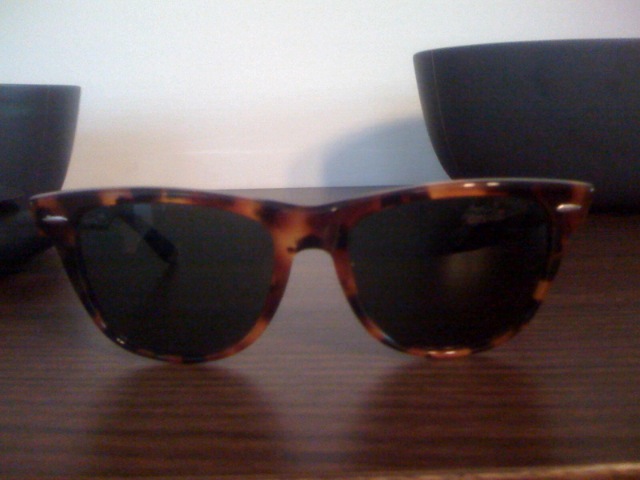 a pair of sunglasses with black frames are on the table