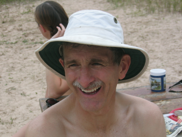 an old man with a hat and mustache