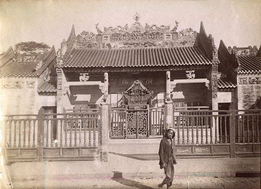 an old picture shows a man standing in front of a building
