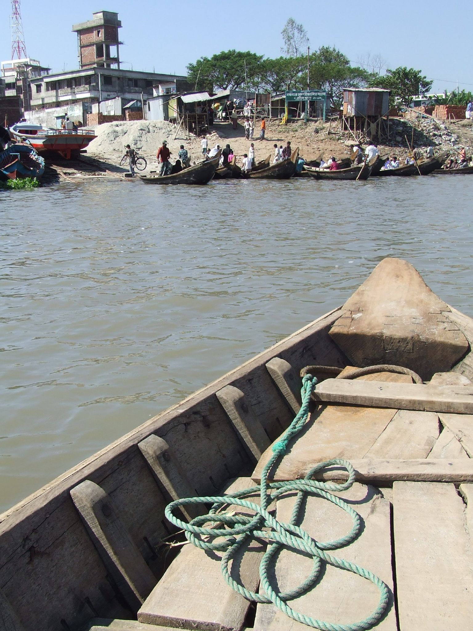 a long wooden boat is in a body of water