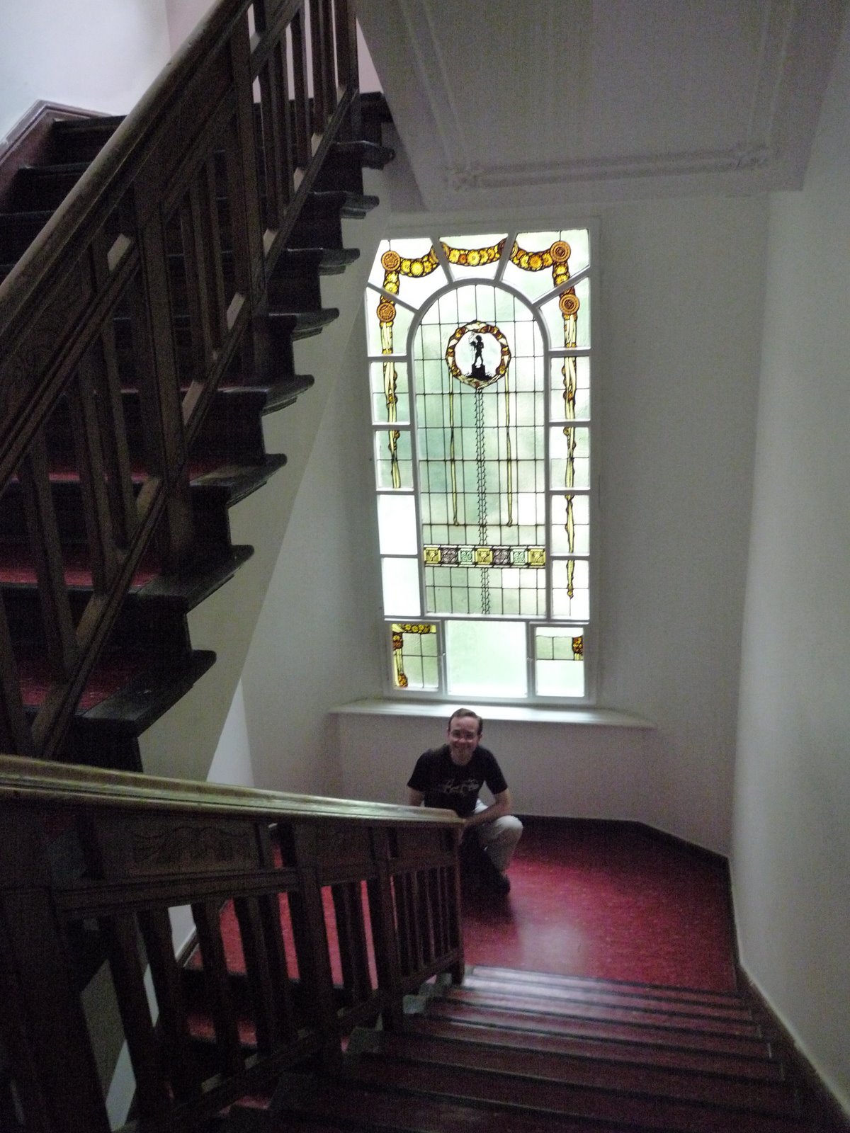 a person sitting on the ground at the bottom of a stair case