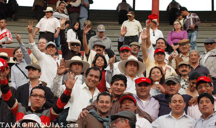 group of people in a stadium with flags