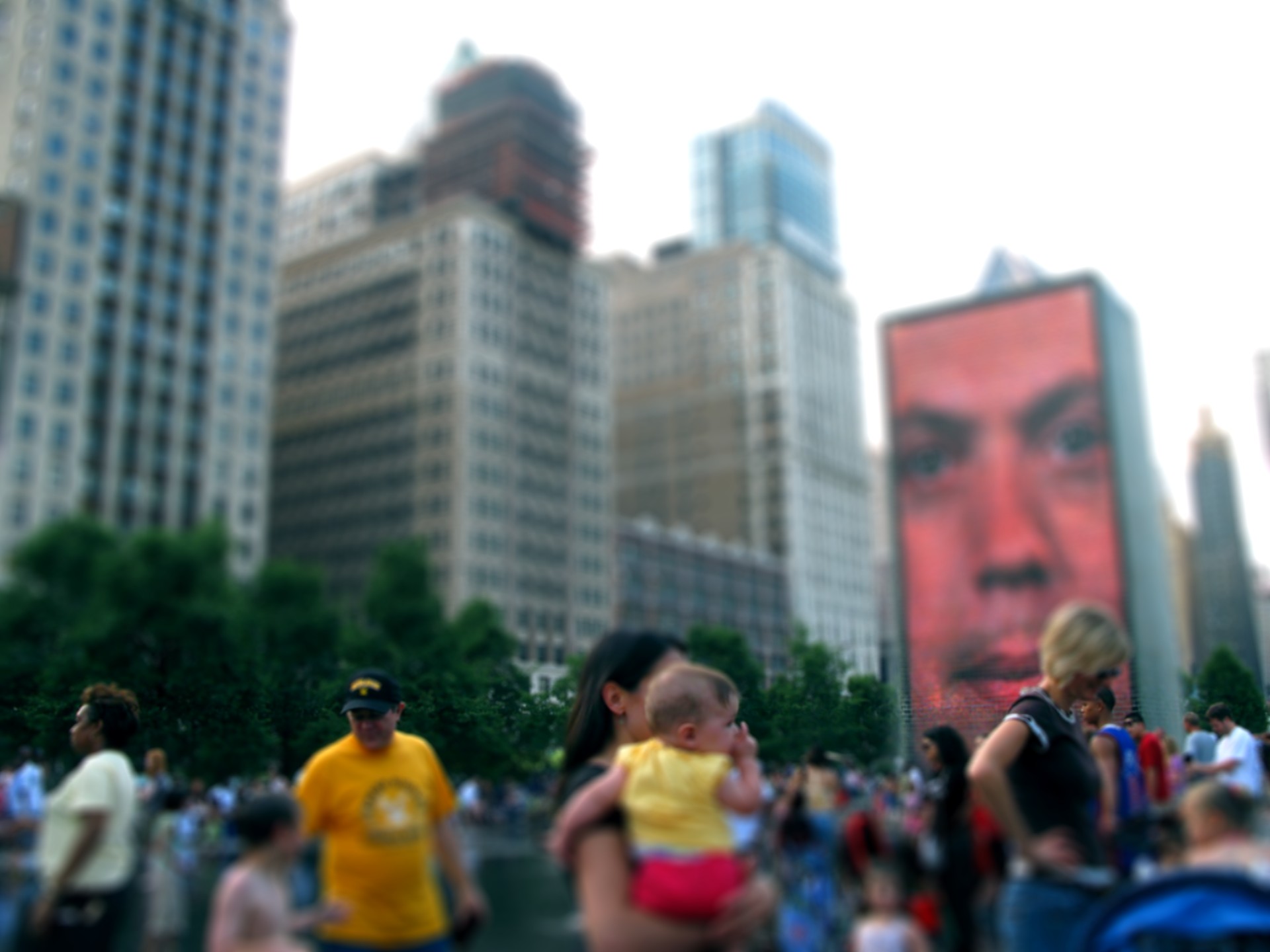 a crowd of people on a street, some with backpacks