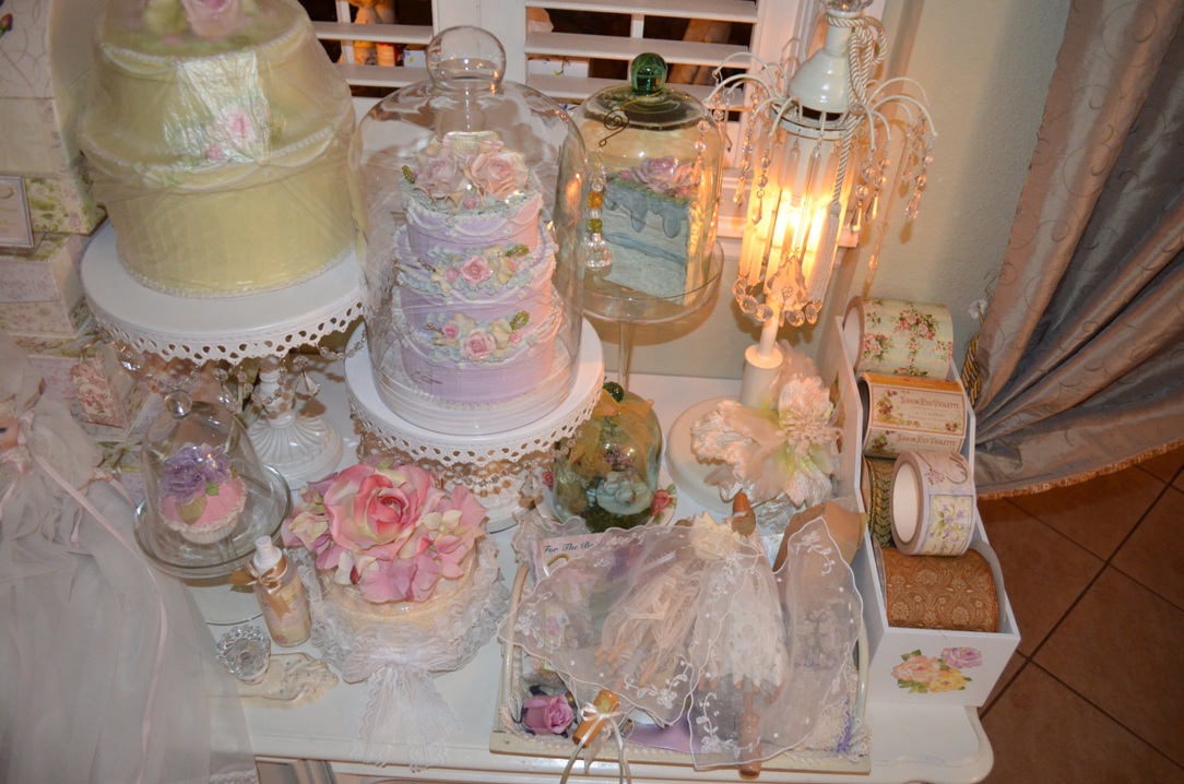 a table is covered with wedding cakes and cupcakes