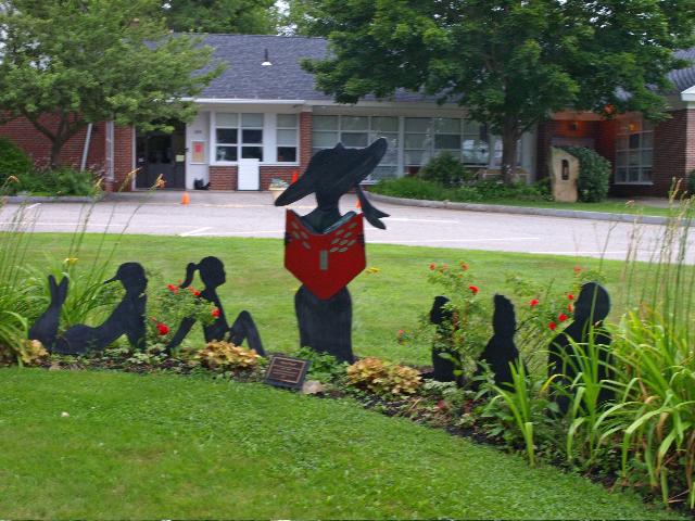 a lawn with various sculptures and flowers