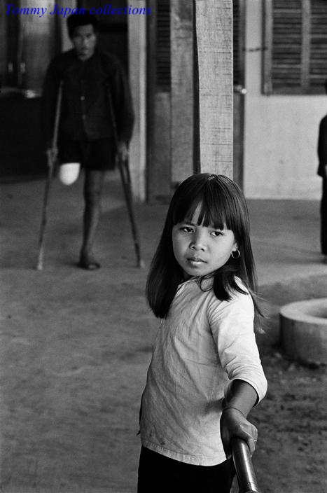 black and white po of girl with umbrella in front of building