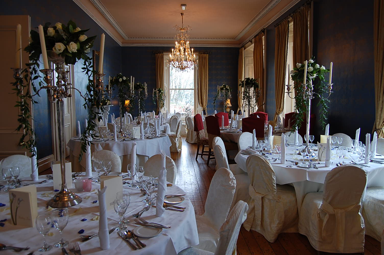 a banquet hall filled with white tables and chairs