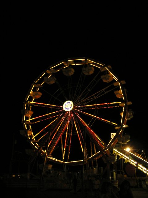 a large ferris wheel with red and white lights