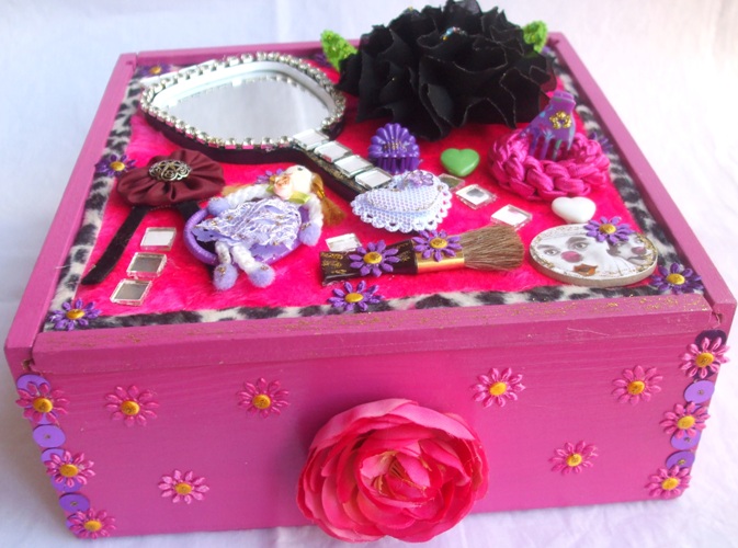a pink suitcase with hair accessories and flowers