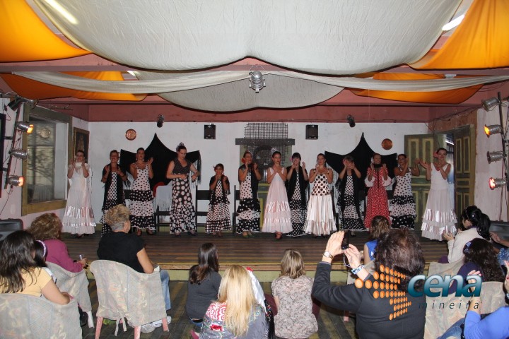 some women standing on the stage at a dance