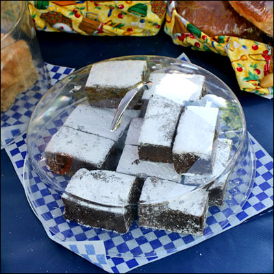 chocolate brownies with powdered sugar sitting on a plate