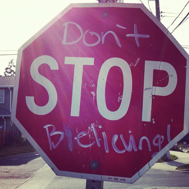 a stop sign with some writing on it