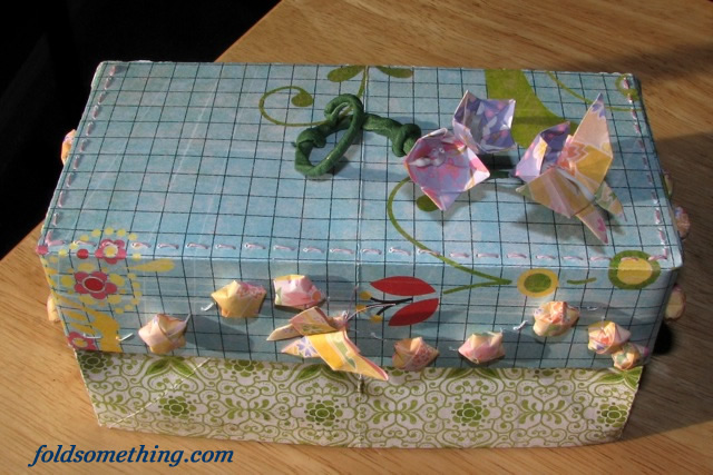 a decorative tissue box with flowers on it