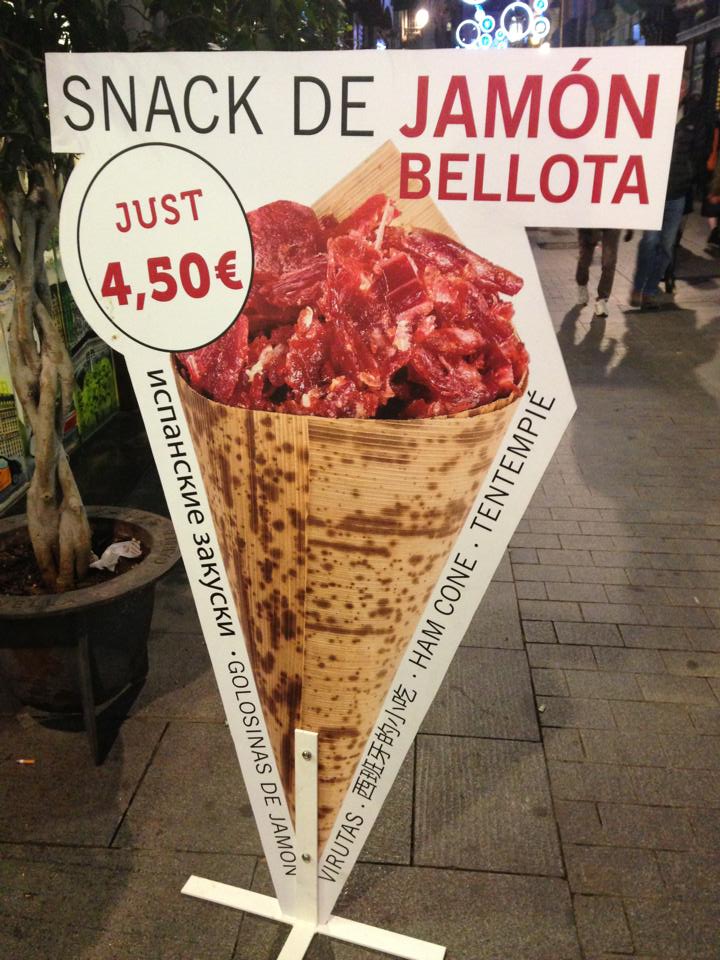 a large paper cone with meat cut into triangles