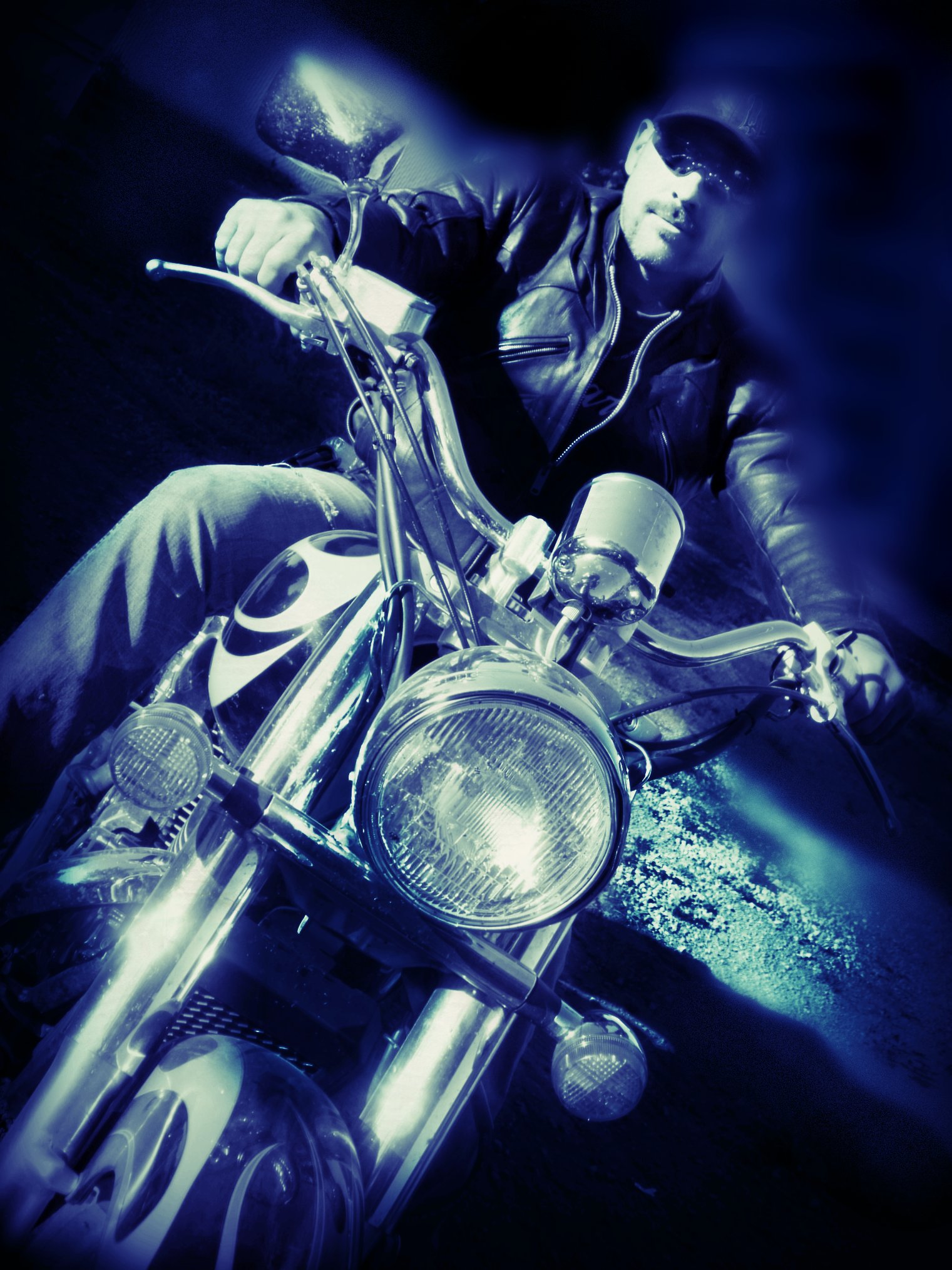 man on a motorcycle in a po with blue light