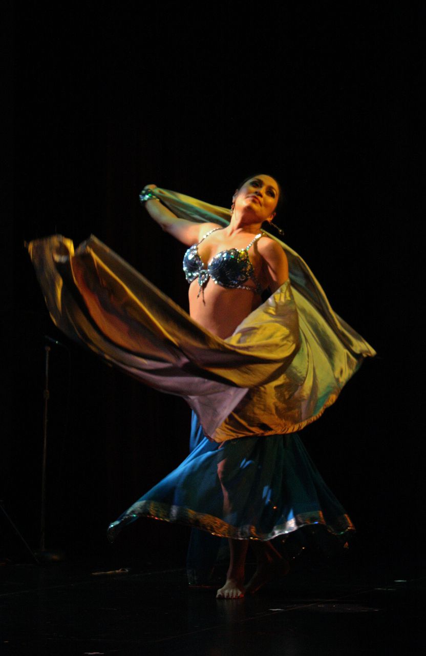 a woman in a belly wrap dances with her hands