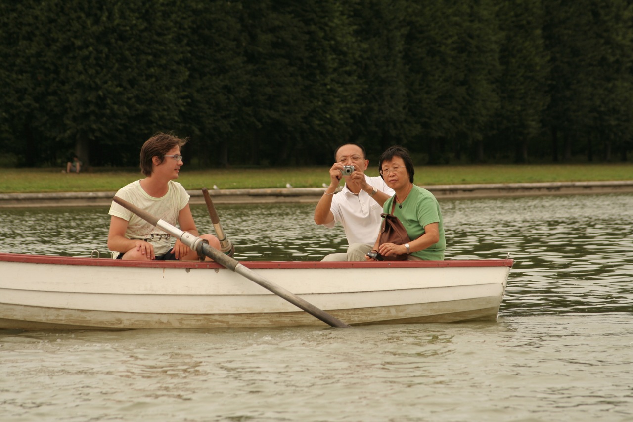 a group of people in a small boat on water