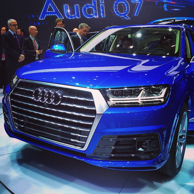 the blue automobile is on display at the auto show