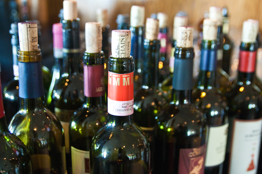 a counter full of wine bottles sitting next to each other