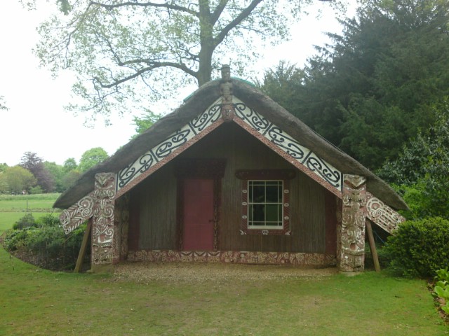 a small home sitting on top of a lush green field