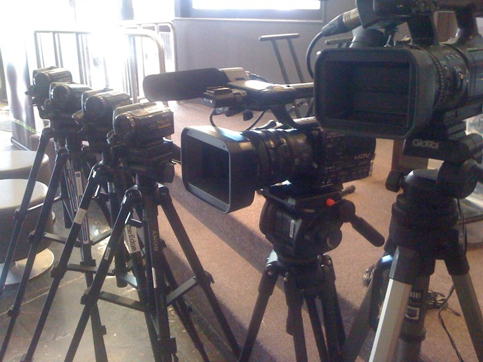 cameras sitting on a table in front of mirrors