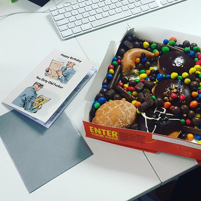 a box of chocolate covered donuts sitting on top of a table