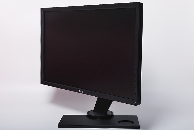 a black monitor is on top of a black stand
