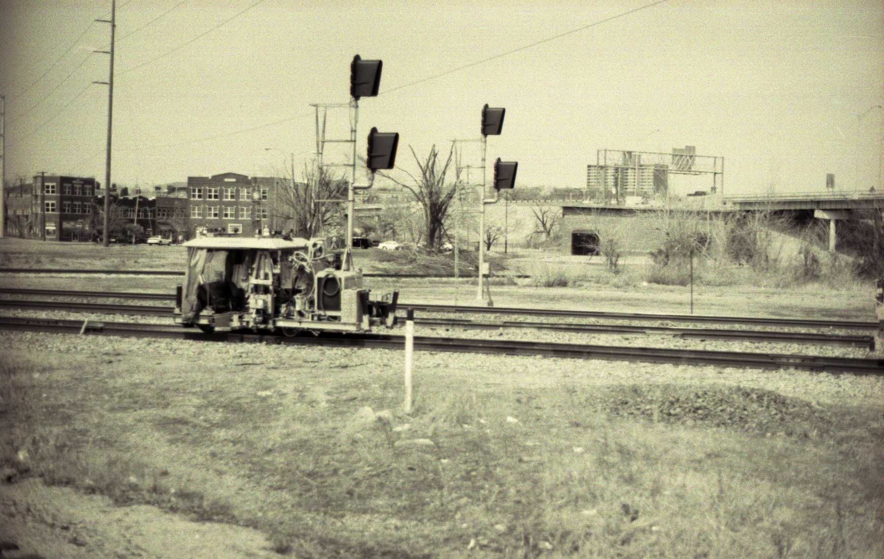 a vintage picture of an old train traveling through the country