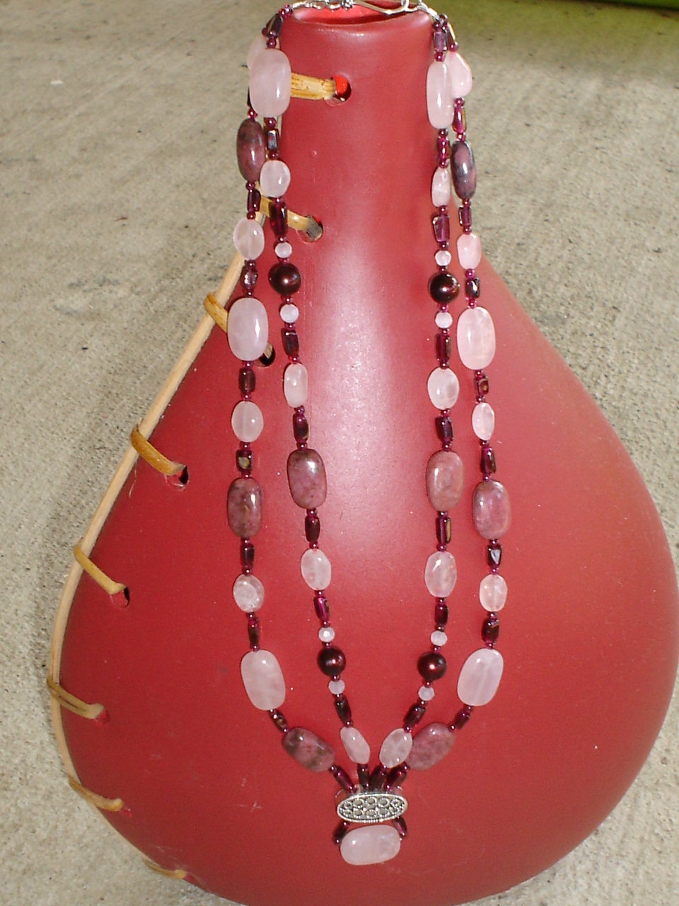 a necklace of various colors in pink and purple