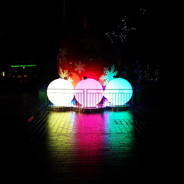 three light balls stand on a brick walkway