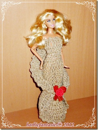 a crocheted barbie doll with long hair wearing a dress