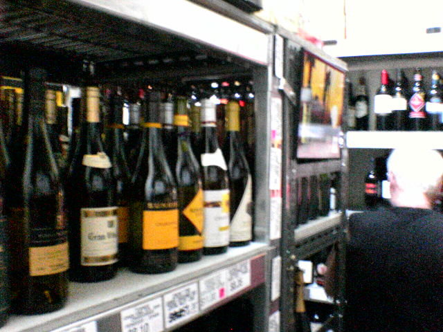 a couple of people shopping for some wine