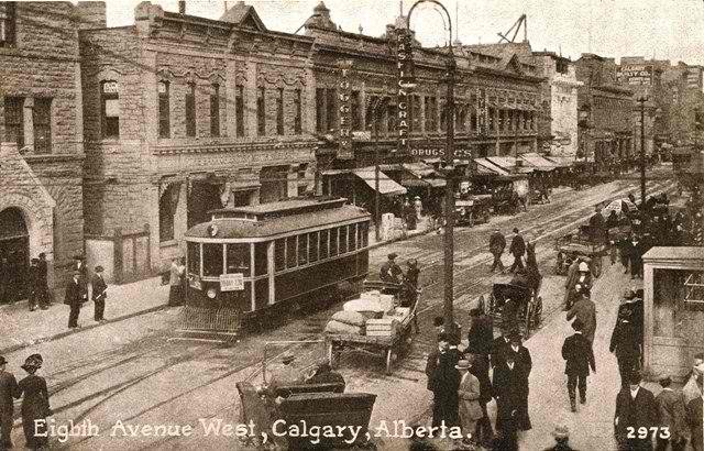 an old picture of a trolley passing through town