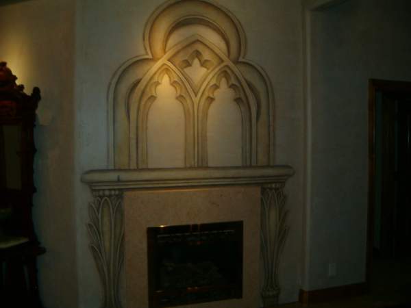 a beautiful fireplace surround with an ornate window