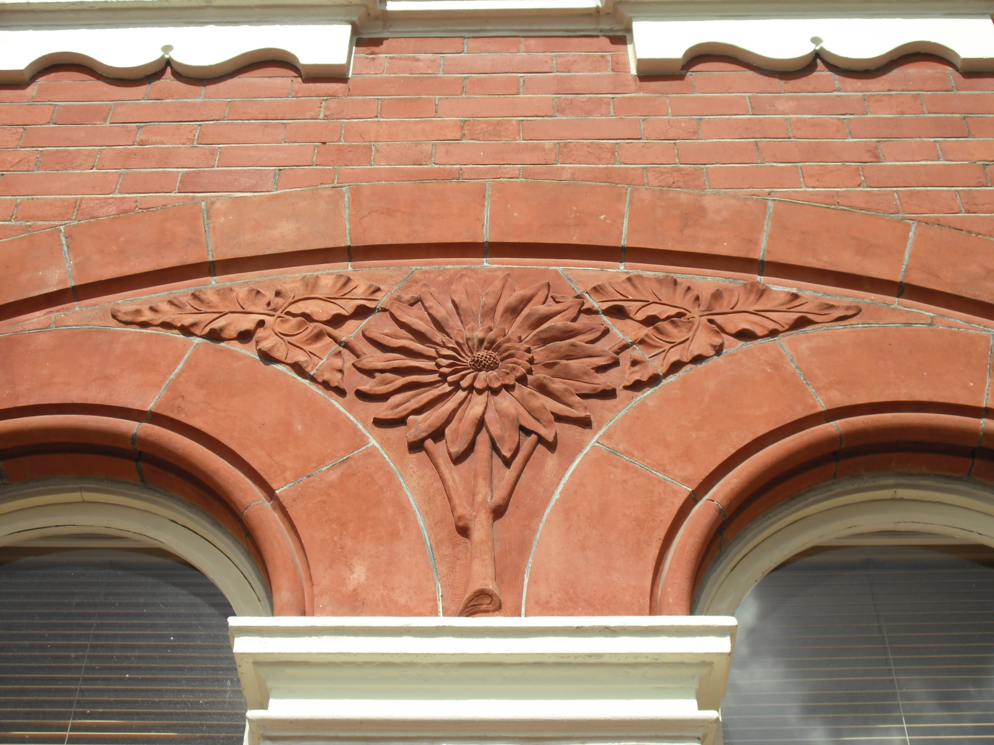 a decorative, floral stone arch on an old building