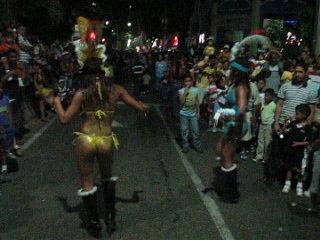 a girl rides her scooter while dressed as an exotic dancer