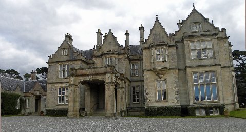 a castle like house with large porchs and multiple windows