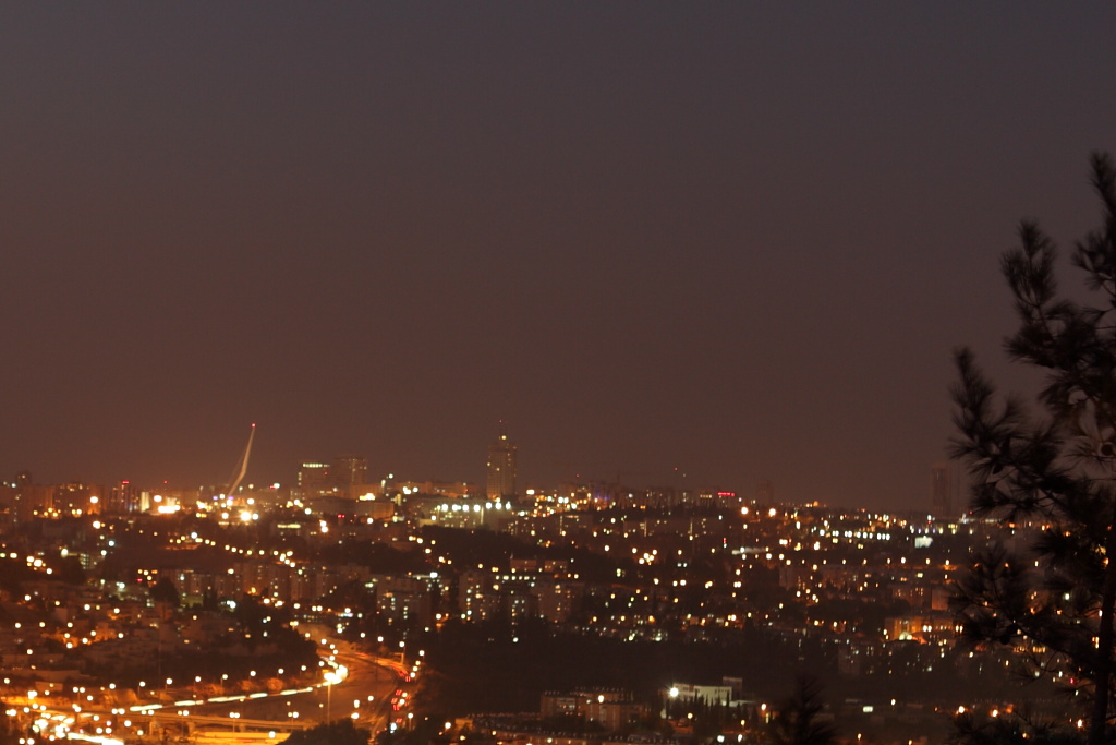 a night view of a city with traffic on it