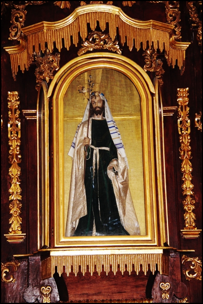 a wooden shrine with the image of jesus hanging from it