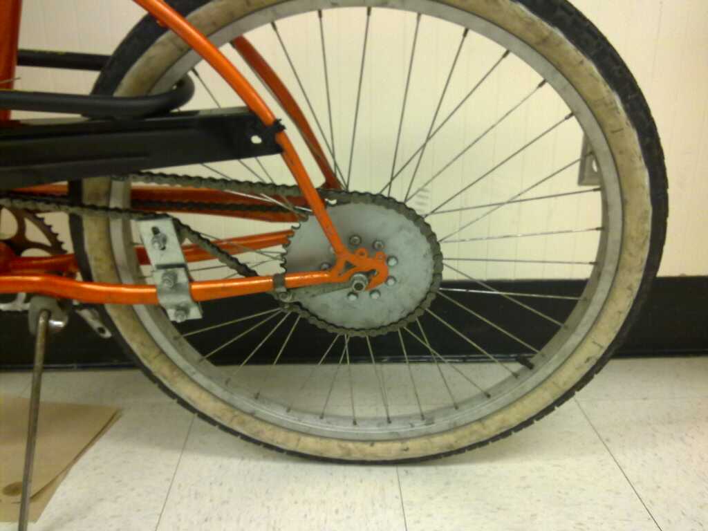 the spokes on the bicycle are worn orange