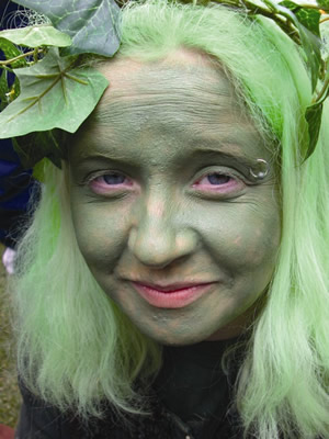 an image of a woman wearing makeup and green hair