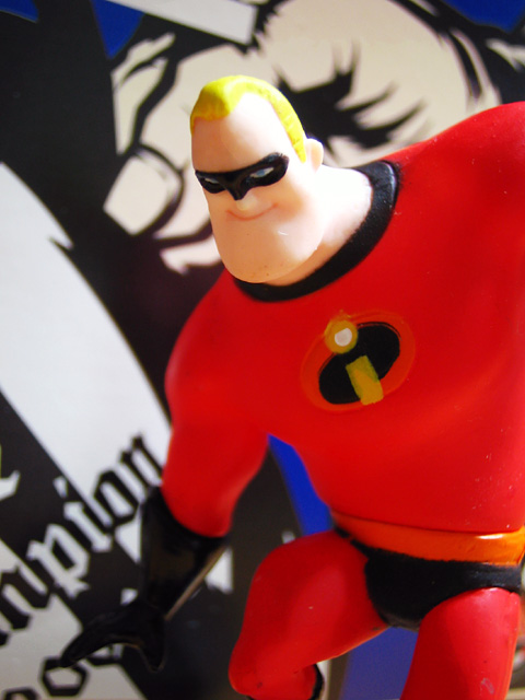 a close up po of a action figure on the back of a skateboard