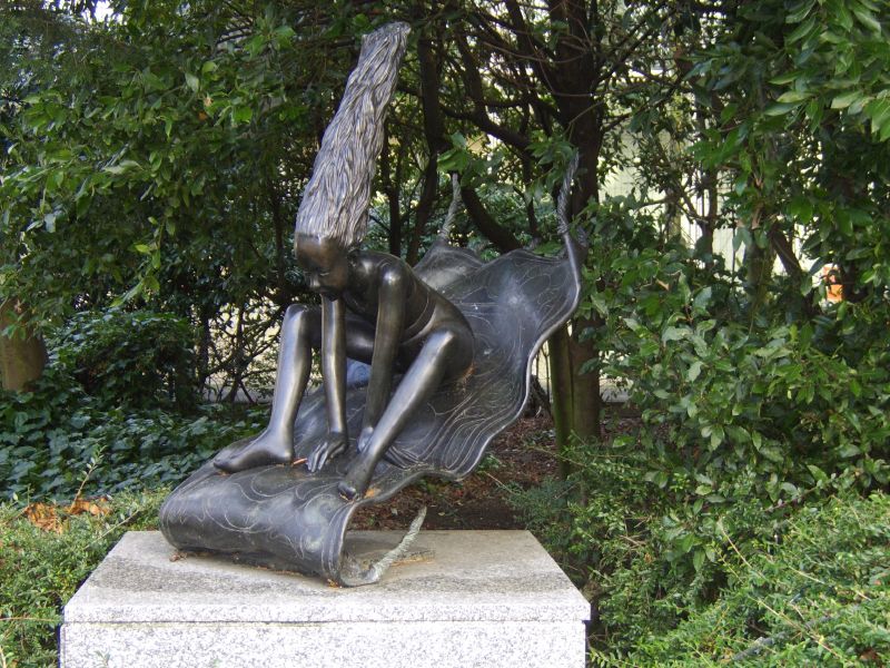 a statue of two women on their backs and one holding her head