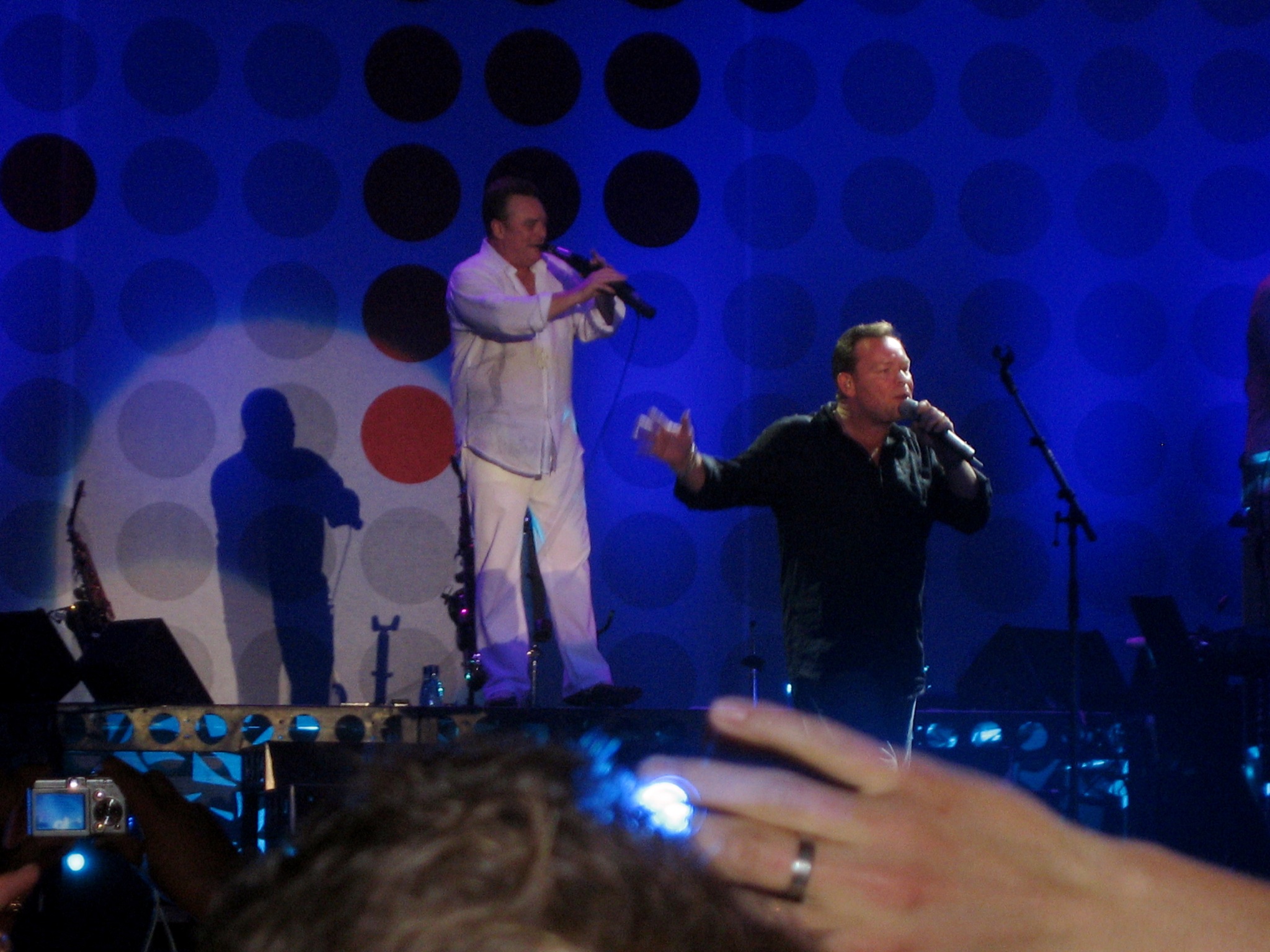 a male and female in white outfit performing