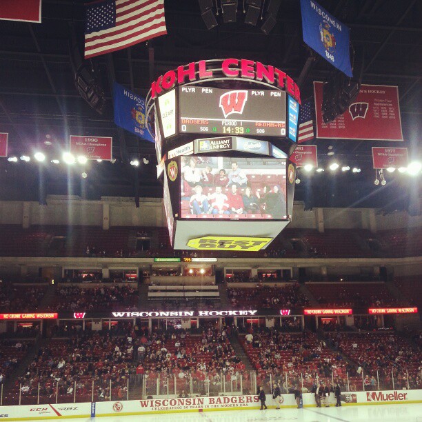 a hockey stadium with the scoreboard, seating and lights