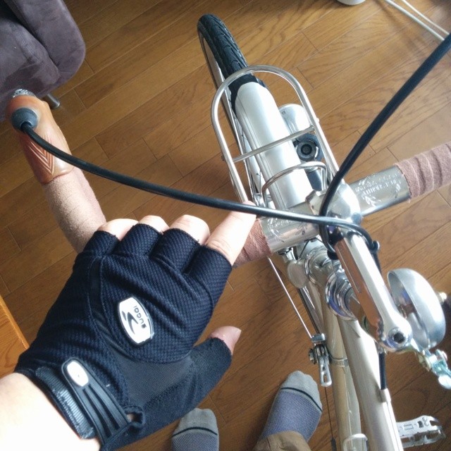 the bike rider wears a large black glove and sits on his bicycle